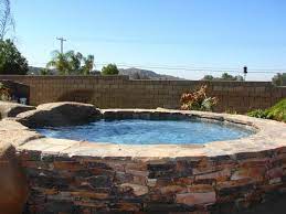 With us, your pool tile is cleaned and beautifully restored in just a few hours. Stone Hot Tub With Stone Surround Pool Tile Riverside Ca With Rustic Stone Hot Tub Stone Pool Country Pool Pool Hot Tub