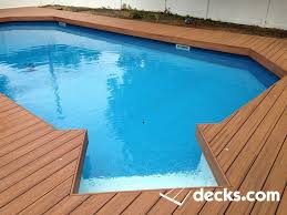 A Composite Deck Wraps Around An In Ground Pool Deck Railing Design Decks Around Pools Hot Tub Deck