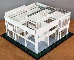 The design attempts to simulate the presence of trees, which are nonexistent on the barren site, through the use of a sequence of columns and wall. House Ii Under Construction