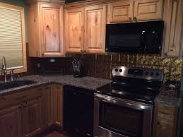 Wood cabinets add natural warmth to kitchens of every size and style. Natural Stain Knotty Alder Kitchen Cabinets Gold Tile Backsplash Dark Granite Counter Top Kit Alder Kitchen Cabinets Alder Cabinets Cheap Kitchen Cabinets