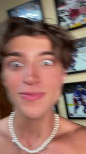 Shirtless Individual Showcases Pearl Necklace