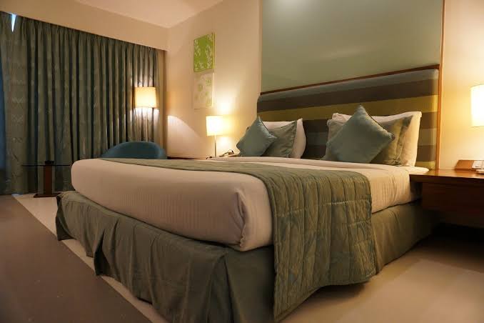 The Purpose of Fabric Strips on Hotel Beds