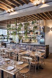Open Kitchen Separated By Hanging Shelves Restaurant Layout Bar Design Restaurant Restaurant Interior Design
