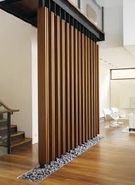 Love The Strutured Wooden Wall Screen The Little Grey Rocks Are So Nature Inspired Room Partition Designs Modern Staircase Partition Design