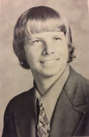 High school senior photo 1977. Now "65" 2024.