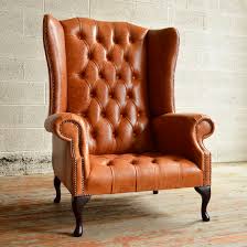 A compact chesterfield with an art deco bend. Chesterfield Armchair Boss Abode Sofas Velvet Leather Mahogany
