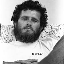 Laid back, lens ready. This portrait of photographer Dan Merkel is a time  capsule from the golden era of surf culture—when he was deep in the field  capturing raw, untamed moments for