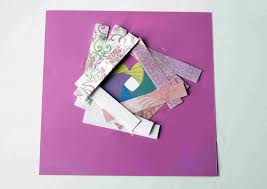 Strips of paper are folded in half and then stacked and taped in a spiral design. A Guide To Learning Iris Folding