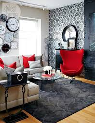 This new york house features a gorgeous living room that is dressed with a stylish white couch, plush rug, a rustic coffee table and a fluffy chandelier. Black And White Rooms With Red Accents Brighten Up Loft In Toronto