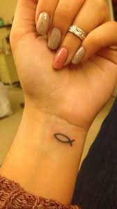 A creative piece which has the jesus fish carved around the cross in red color. 11 Trendy Fish Tattoo Designs For Women Pretty Designs Best Tattoos For Women Tattoos For Women Tattoos For Women Small