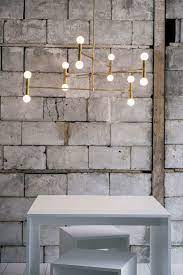The Brass Trend Continues We Currently Have Our Eyes On The Bare Bulb Elegance Of Lambert Fils Lighting Inspiration Minimalist Chandelier Interior Lighting