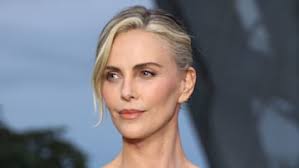 Charlize Theron, 48, is all legs in unforgettable white dress