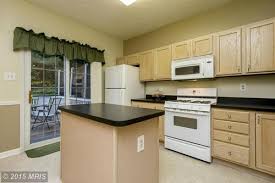 Black and gray granite countertops will create a dramatic look that is well suited for contemporary style kitchens. Help Kitchen W Pickled Oak Cabs And Black Counters