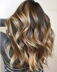 Blonde curly hair dye on dark brown hairstyle. 29 Brown Hair With Blonde Highlights Looks And Ideas Southern Living