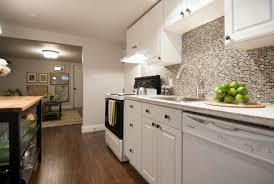 You can hide the cords for a cleaner look, or leave them exposed for a more industrial and raw aesthetic, which is very appropriate for basement spaces. Open Concept Basement Apartment Income Property Hgtv Apartment Kitchen Basement Apartment Grey Kitchen Walls