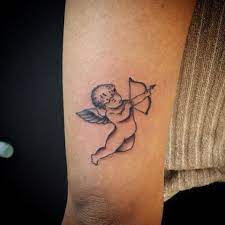20 Lovely Light Disturbingly Dark Angel Tattoos Cupid Tattoo Angel Tattoo Baby Angel Tattoo