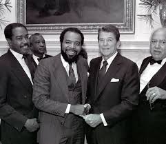 On this day in 1981 President Reagan with E.Dole, Tony Brown, William  Harvey, John Adams, Thomas Dortch, and Leonard Spearman held a luncheon  after the POTUS signed the executive order to designate