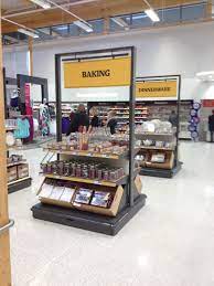 Open Plan Store Display With Different Items For Sale Kitchen Stuff Clothes Grocery Furniture Etc Store Layout Supermarket Design Retail Store Design
