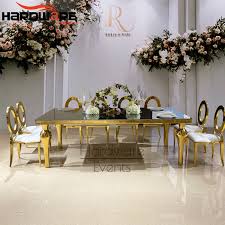 Dining tables are hot spots even when there's no food on them. China High Quality Gold Stainless Steel Base Glass Dining Table Set For Event China Event Table Gold Wedding Backdrop