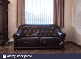The shabby chic living room has been popular since many years ago. Old Leather Brown Sofa Near The Window In Vintage Living Room Antique Retro Design Needs Renovation Stock Photo Alamy