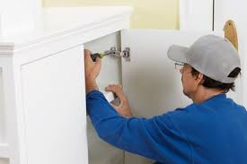 Man Installing Euro Style Hinges Inside Cabinet Cabinet Hinges Cabinet Styles Kitchen Cabinets Hinges