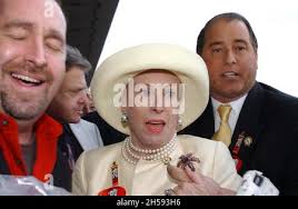 Marylou Whitney and her husband John Hendrickson, left, present the trophy  to Brent Johnson