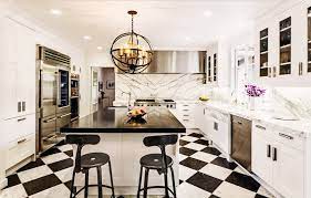 Minimalist black kitchen with modern cabinetry along with a black countertop and black appliances. Kitchen With Black And White Floors Contemporary Kitchen Svz Interior Design