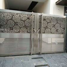 A rustic stone archway and wooden door give the entrance to this scenic yard the look and feel of a hidden passageway. Flying Butterfly Design Gate Wall Design Steel Gate Design Grill Gate Design