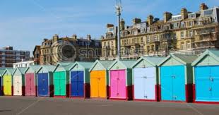 Beach hut row in pastel colors, red rock background. Beach Huts In Brighton Hove Brighton Beach Melbourne Brighton Beach Uk Brighton England