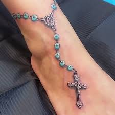 Beautiful rosary foot tattoo beads tart off from the calf of the foot, going down the ankle bone and attaching itself to a small black shining diamond shape. 60 Awesome Rosary Tattoos