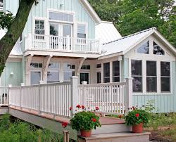 This home exterior has cedar shake siding in sherwin williams 2851 sage green light stain color with cedar trim and natural stone accents. Best Exterior House Color Schemes Better Homes Gardens