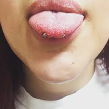 Perforation of a thin tissue (frenulum) between the lower lip. Snake Eyes Piercing 50 Ideas Pain Level Healing Time Cost Experience Piercee