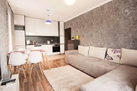 A modern white living room chair and sofa match a statement spiral staircase in this striking space. Modern Bright And Cozy Living Room Interior Design With Sofa Dining Table And Kitchen Grey And White Studio Apartment Stock Photo Picture And Royalty Free Image Image 109508111