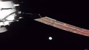 Orion spacecraft with Earth rising over the Moon
