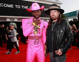 He donned a bubblegum pink versace cowboy outfit featuring studs and a harness. Lil Nas X And Billy Ray Cyrus Take Home Another Grammy