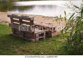 How to disassemble a pallet efficiently : Outdoor Furniture Made From Wood Pallets On The Shore Of A Tranquil A Lake Surrounded By Trees And Greenery In Summer Canstock
