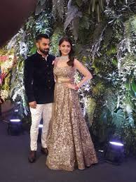 Celebrity Couple Reception Photo Indian Reception Outfit Indian Reception Dress Reception Dress Dressed in a gold and hot pink lehenga designed by sanjay garg, soha. indian reception outfit