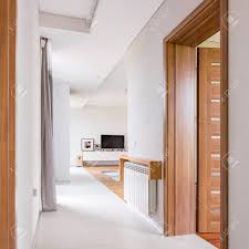 These beautiful parisian hex porcelain tiles are truly inspiring. Modern Home Interior With Wooden Door White Walls And Floor Tiles Stock Photo Picture And Royalty Free Image Image 98355191