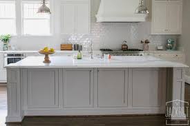 In this kitchen, the natural cream and beige hues work with the gray flecks in the countertop to pull together the suede grey cabinets, as well as the beautiful mosaic backsplash. White Kitchen Cabinets Grey Marble Countertops Design Ideas