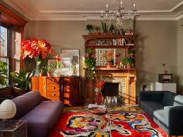 The kayla sofa features a green velvet upholstery around the frame with chrome legs. The Apartment Tour Of A Moma Collection Specialist Architectural Digest