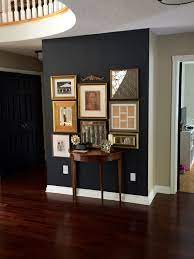 Wrought iron is one of those materials of old that's proven itself. Benjamin Moore Wrought Iron Gallery Wall With Gold Frames Black Accent Wall Living Room Accent Walls In Living Room Dining Room Paint
