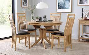 Gather round the table and choose from a selection of affordable and stylish dining room tables. Hudson Round Oak Extending Dining Table With 4 Bali Chairs Brown Leather Seat Pads Furniture And Choice