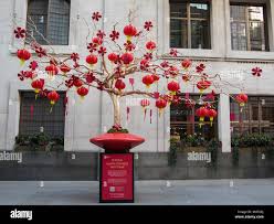 Chinese Lanterns On Display In Large Bonsai Style Wishing Tree In Regent Street With Red Envelopes For Good Luck Stock Photo Alamy