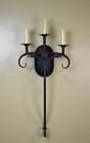 Wall sconces are just the thing to install in your home for the perfect level of lighting, while also saving floor and table space that normally gets taken up by larger luminaries. Hacienda Triple Spanish Style Sconces Forja Lighting Sconces Candle Wall Sconces Spanish Furniture Hacienda Style