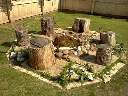 Homemade Fire Pit From Rocks And Tree Stumps For Stools Fire Pit Backyard Backyard Fire Homemade Fire Pit