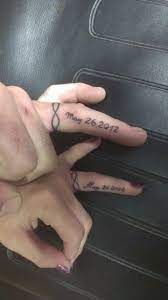 Generate name tattos on ring finger. 60 Awesome Wedding Ring Tattoos Weddingomania