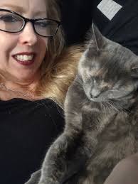 Merlin snuggles with staff and family again