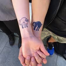Black And White Cat Tattoo Sneaky Black White Cat Tattoos Black Cat Tattoos Cat Tattoo Designs Cat Tattoo