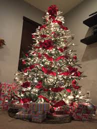 Flocked Tree Red Ribbon And Red And Silver Ornaments With A Hint Of Gold Ribbon On Christmas Tree Christmas Tree Red And Silver Christmas Decorations Rustic