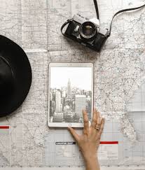 Flat Lay Photography Of Person Touching Silver Ipad On World